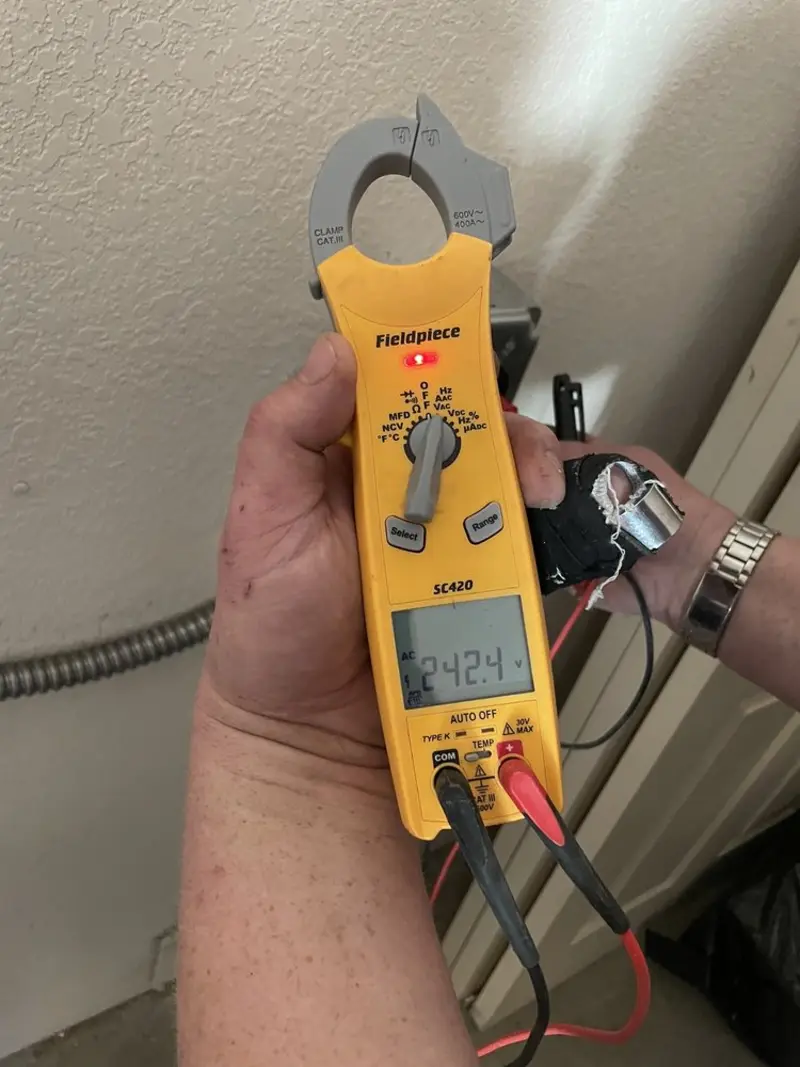 Voltage testing with clamp meter during Whole House Surge Protector in Pelham
